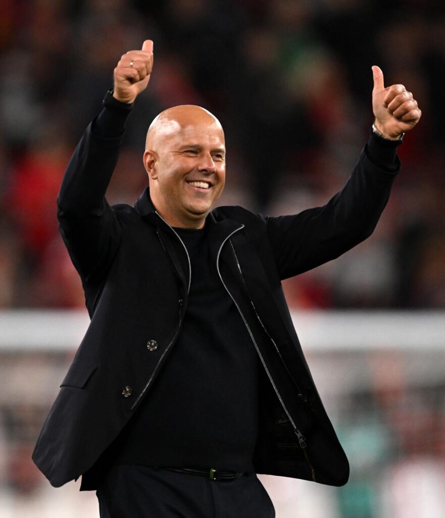Liverpool manager Arne Slot smiling on the touchline during a Premier League match
