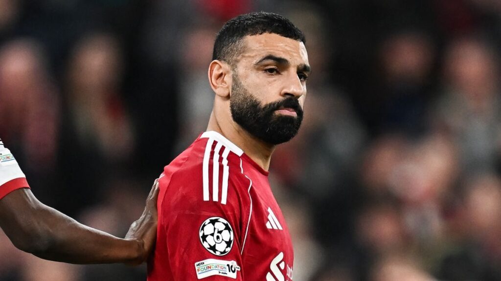 Mohamed Salah applauding Liverpool fans at Anfield wearing the red home kit