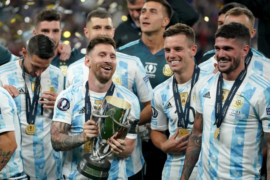 Lionel Messi celebrating with the Argentina squad after winning a major trophy.