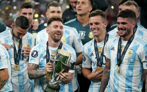 Lionel Messi celebrating with the Argentina squad after winning a major trophy.
