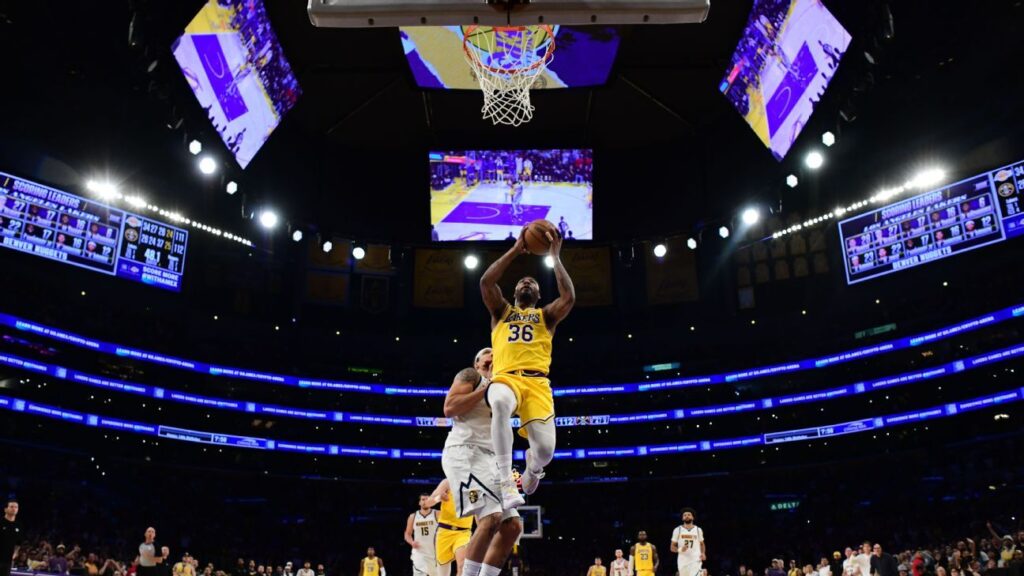 Marcus Smart of the Los Angeles Lakers celebrating a successful defensive play on the court