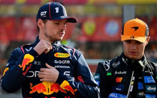 Max Verstappen in Red Bull racing teamwear talking to media in the paddock