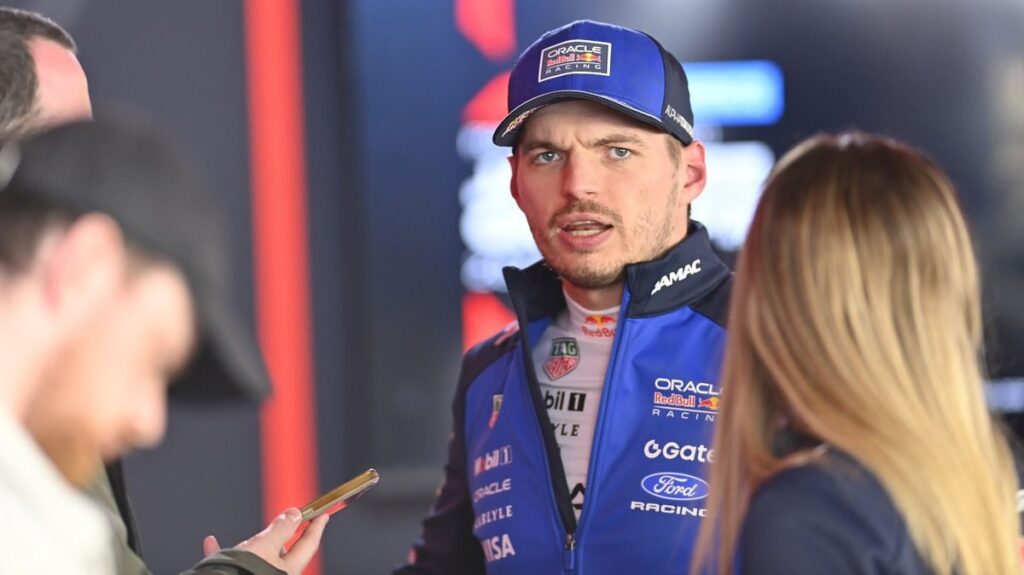 Max Verstappen walking in the paddock wearing his Red Bull Racing team gear