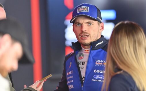 Max Verstappen walking in the paddock wearing his Red Bull Racing team gear