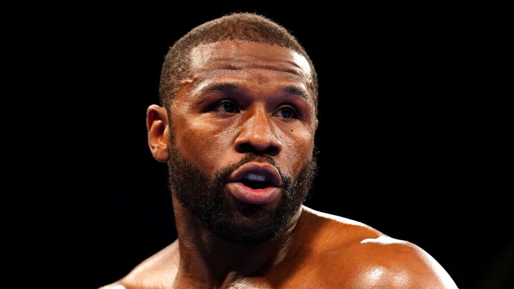 Floyd Mayweather standing in a boxing ring appearing confident