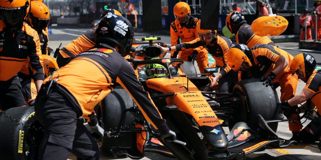 McLaren mechanics work on Lando Norris's car in the pit lane at the Chinese Grand Prix