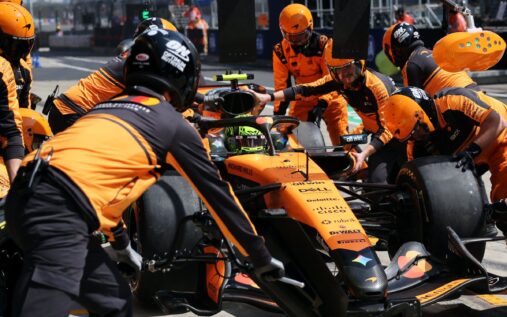 McLaren mechanics work on Lando Norris's car in the pit lane at the Chinese Grand Prix