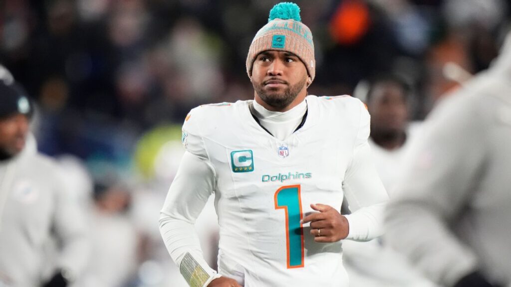 Miami Dolphins quarterback Tua Tagovailoa looking dejected on the field in his team uniform