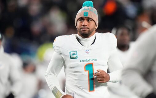 Miami Dolphins quarterback Tua Tagovailoa looking dejected on the field in his team uniform