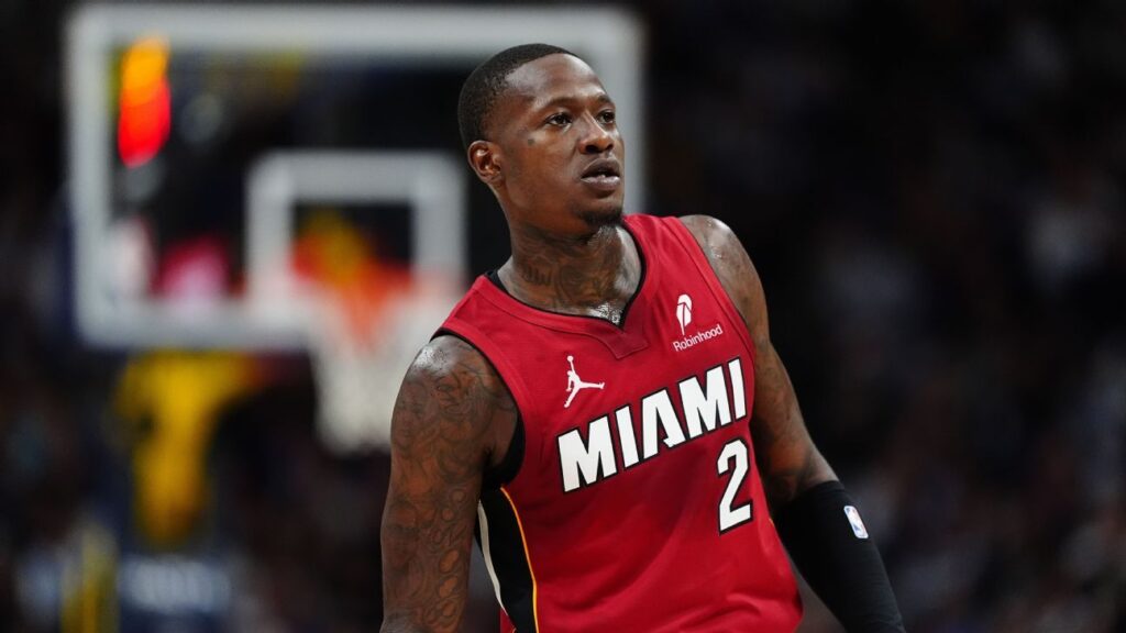 Terry Rozier wearing a Miami Heat uniform dribbling a basketball on the court