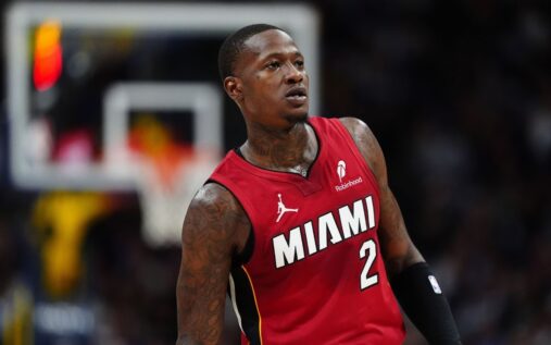 Terry Rozier wearing a Miami Heat uniform dribbling a basketball on the court