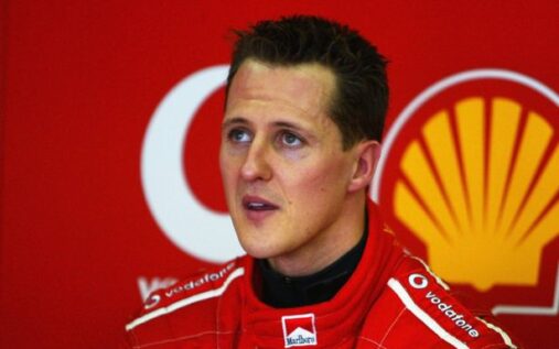 Michael Schumacher celebrating a victory in red Ferrari racewear prior to his retirement