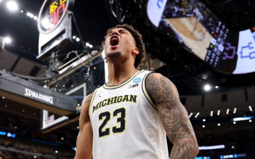 Michigan Wolverines basketball players celebrating their emphatic 95-62 victory over the Tennessee Volunteers