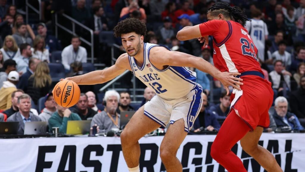College basketball players competing during a high-stakes men's tournament knockout game
