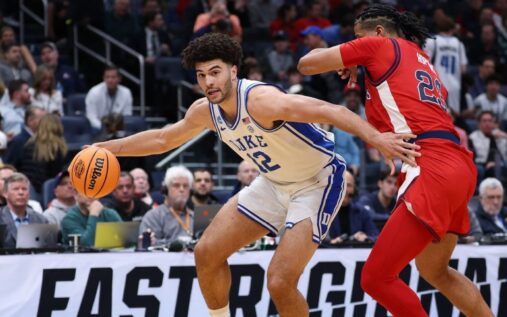 College basketball players competing during a high-stakes men's tournament knockout game