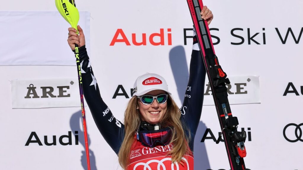 Mikaela Shiffrin skiing aggressively through slalom gates on a snowy course in Sweden
