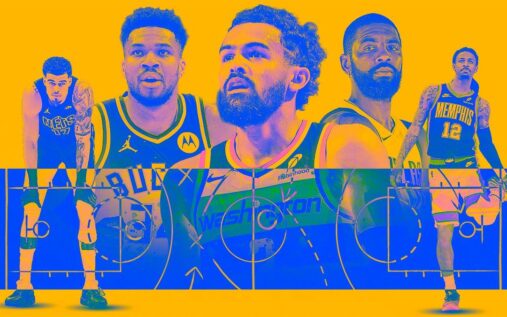 Giannis Antetokounmpo looking thoughtful on the basketball court in a Milwaukee Bucks jersey