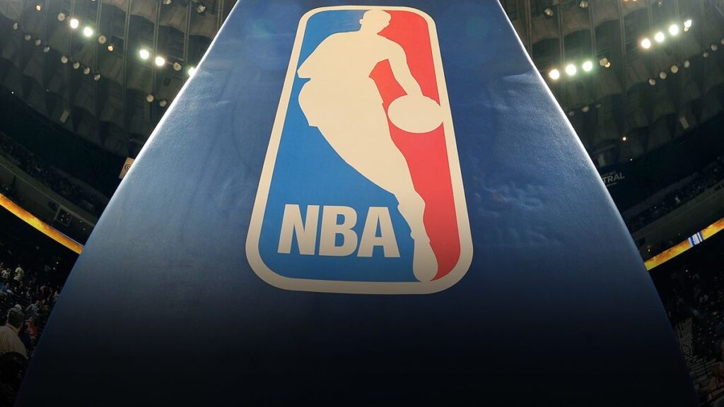 An official NBA basketball resting on a polished hardwood arena court