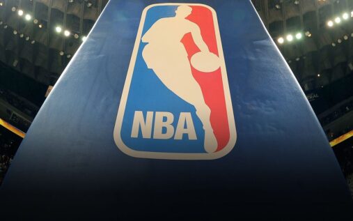 An official NBA basketball resting on a polished hardwood arena court