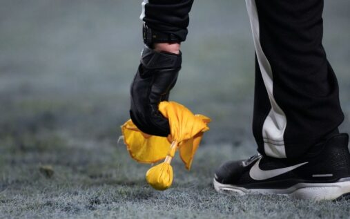 An NFL referee signalling a call on the field during an American football game