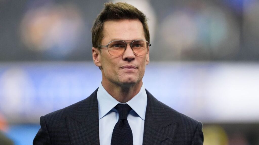 Tom Brady smiling in his role as minority owner of the Las Vegas Raiders