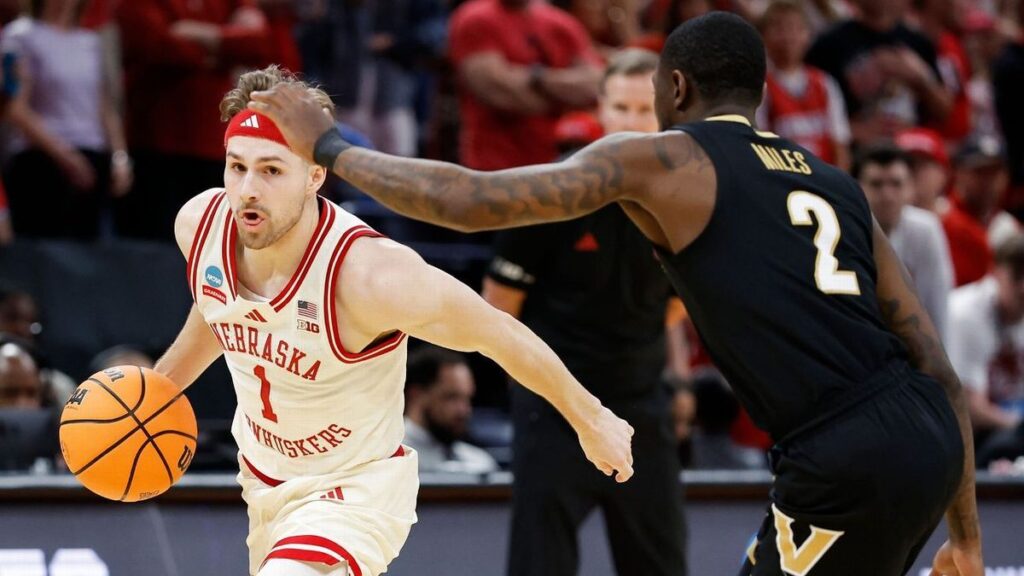 Nebraska basketball players celebrating a dramatic victory on the court