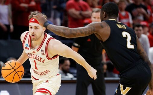 Nebraska basketball players celebrating a dramatic victory on the court