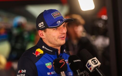Max Verstappen looking frustrated in the Formula 1 paddock wearing his Red Bull team gear