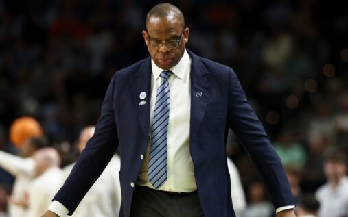 North Carolina head coach Hubert Davis looking dejected on the sidelines during an NCAA tournament basketball game