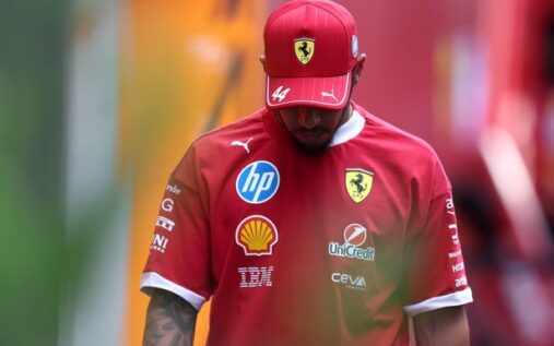 Ollie Bearman wearing Haas team kit speaking into a microphone in the paddock