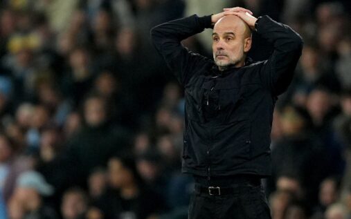 Pep Guardiola looking pensive on the touchline during a Manchester City match