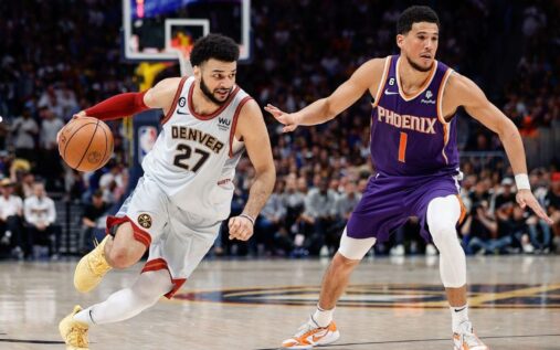 Phoenix Suns and Denver Nuggets players competing on an NBA basketball court