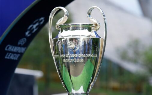 Premier League trophy surrounded by Champions League and Europa League footballs