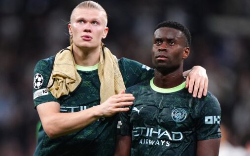 The UEFA Champions League starball logo displayed brightly on a stadium football pitch