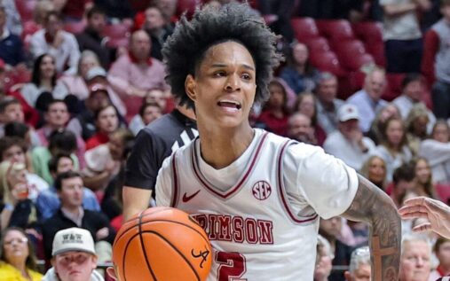 Alabama Crimson Tide basketball guard Aden Holloway looking towards the court during a match