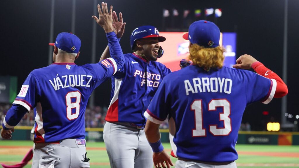 Puerto Rico baseball players with bleached blond hair celebrating on the field at Estadio Hiram Bithorn