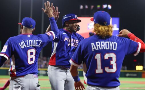 Puerto Rico baseball players with bleached blond hair celebrating on the field at Estadio Hiram Bithorn