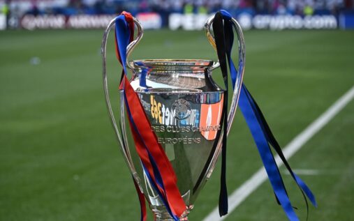 Arsenal players celebrating on the pitch during a Champions League match