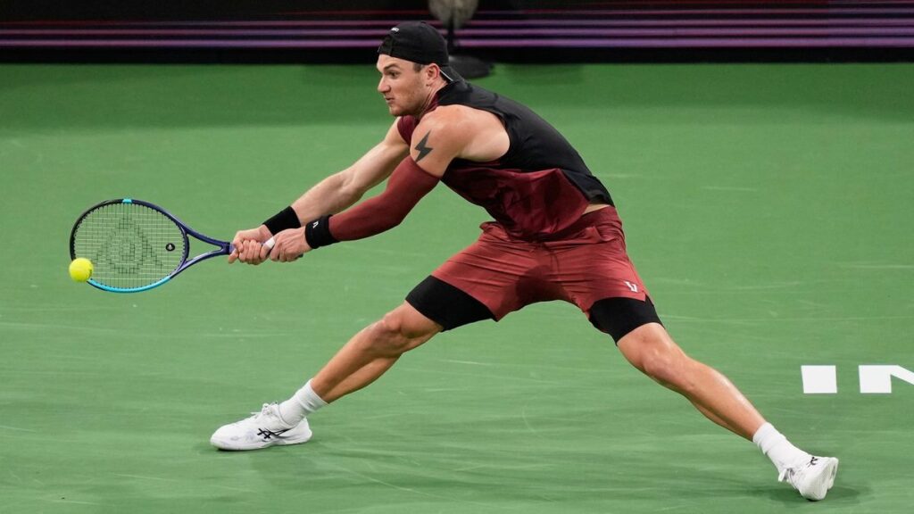 Reilly Opelka serving a tennis ball during his Miami Open match against Jack Draper