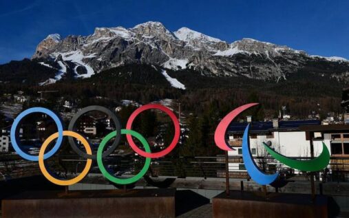 The Paralympic flag flying at a winter sports venue in Italy