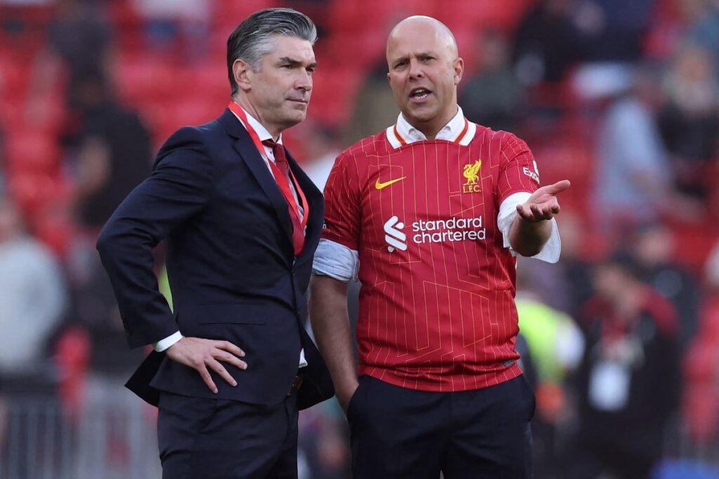 Michael Edwards and Richard Hughes watching a Liverpool match from the stands at Anfield