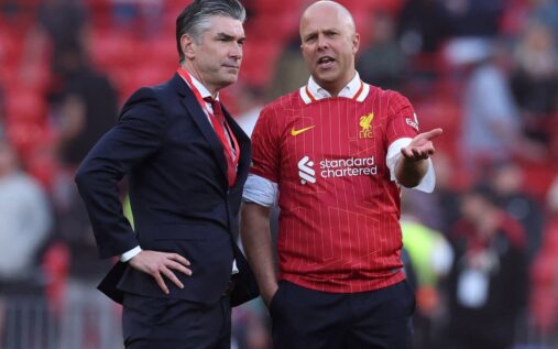 Michael Edwards and Richard Hughes watching a Liverpool match from the stands at Anfield