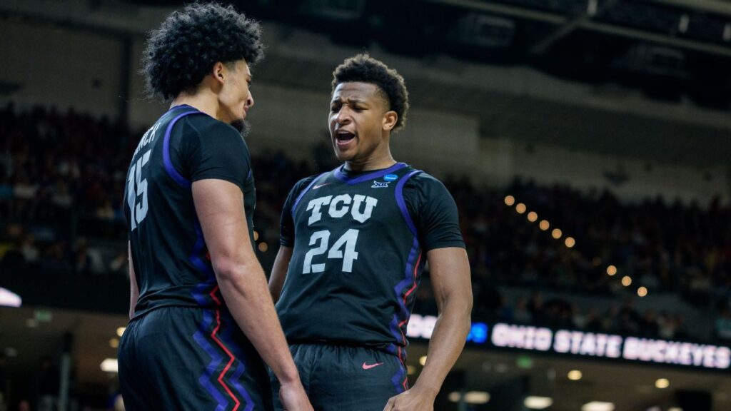 Xavier Edmonds and David Punch celebrating TCU's basketball victory against Ohio State