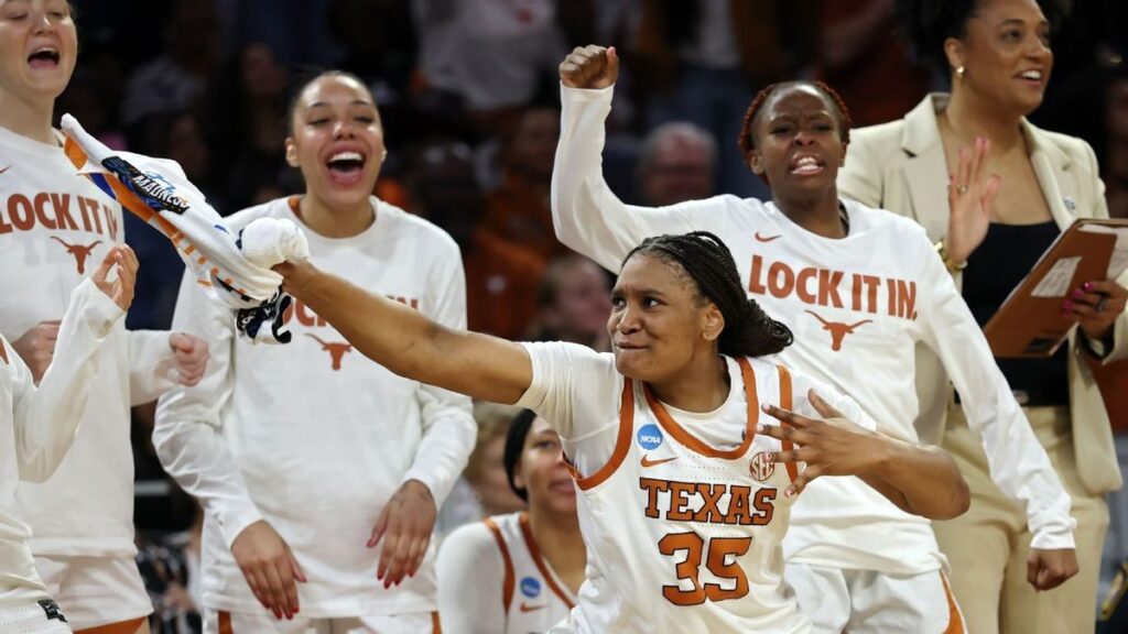 Texas Longhorns women's basketball players celebrating their regional final victory on the court