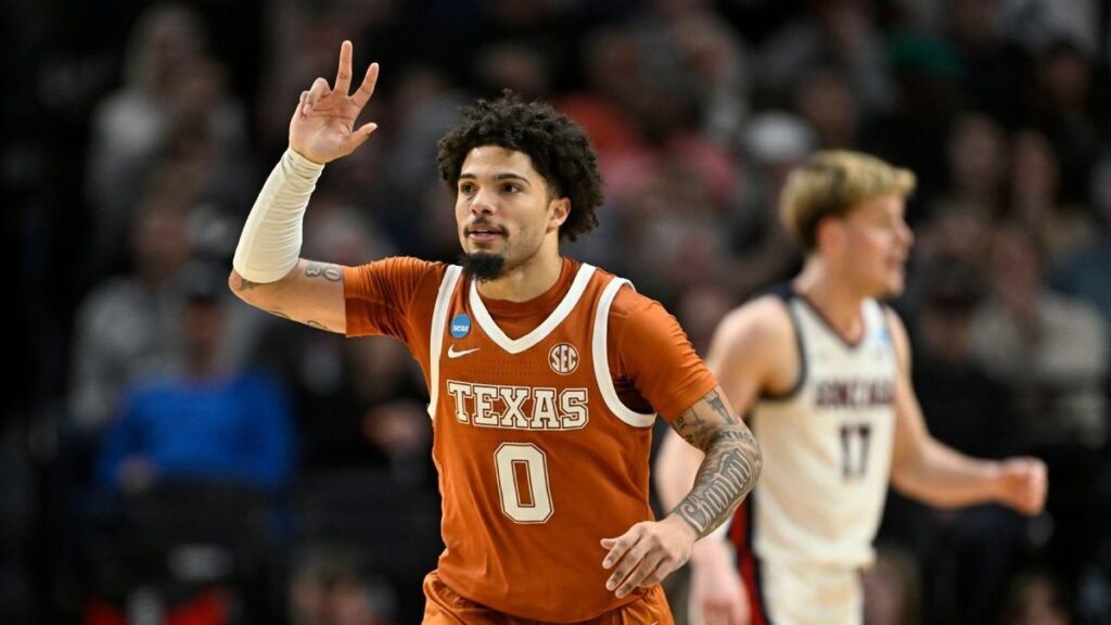 Texas Longhorns basketball players celebrating on court during the NCAA Tournament