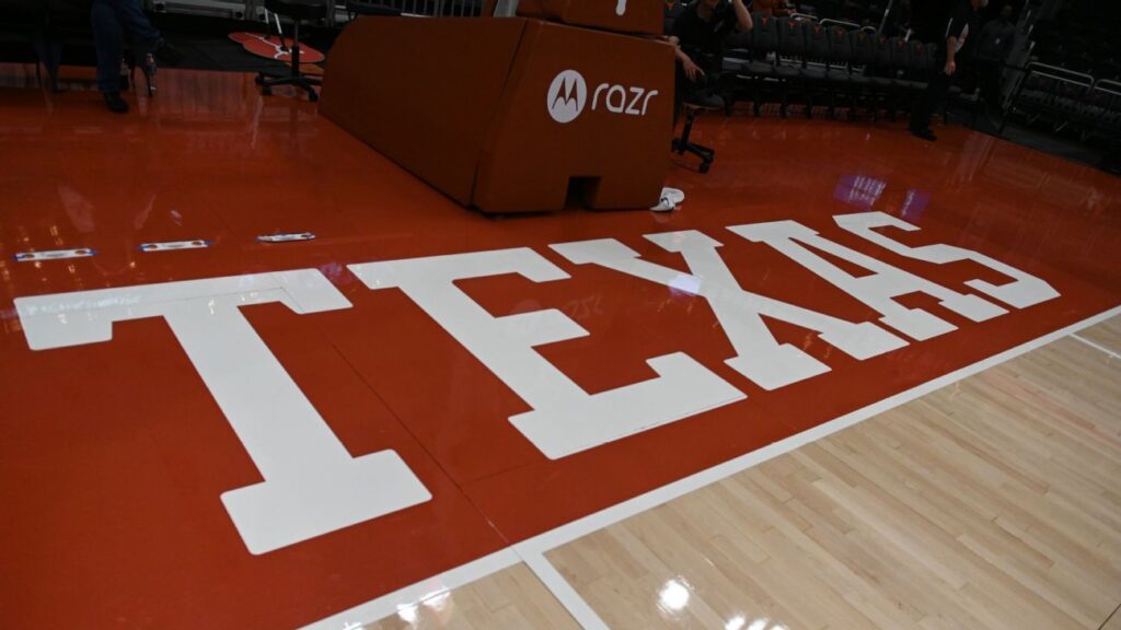 Texas Longhorns players celebrating a basket during a women's college basketball game