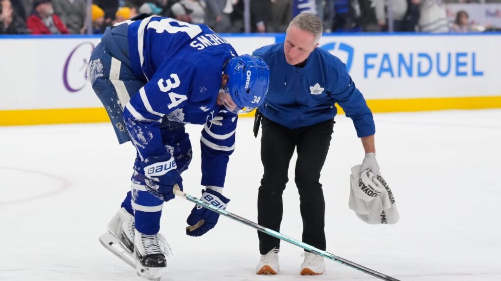 Auston Matthews being helped off the ice by Toronto Maple Leafs medical staff