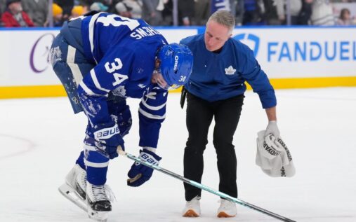 Auston Matthews being helped off the ice by Toronto Maple Leafs medical staff