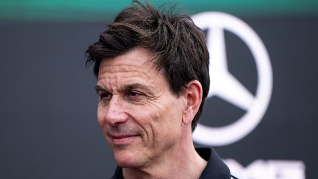 Toto Wolff wearing Mercedes team gear looking thoughtful in the Formula 1 paddock