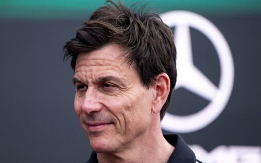 Toto Wolff wearing Mercedes team gear looking thoughtful in the Formula 1 paddock